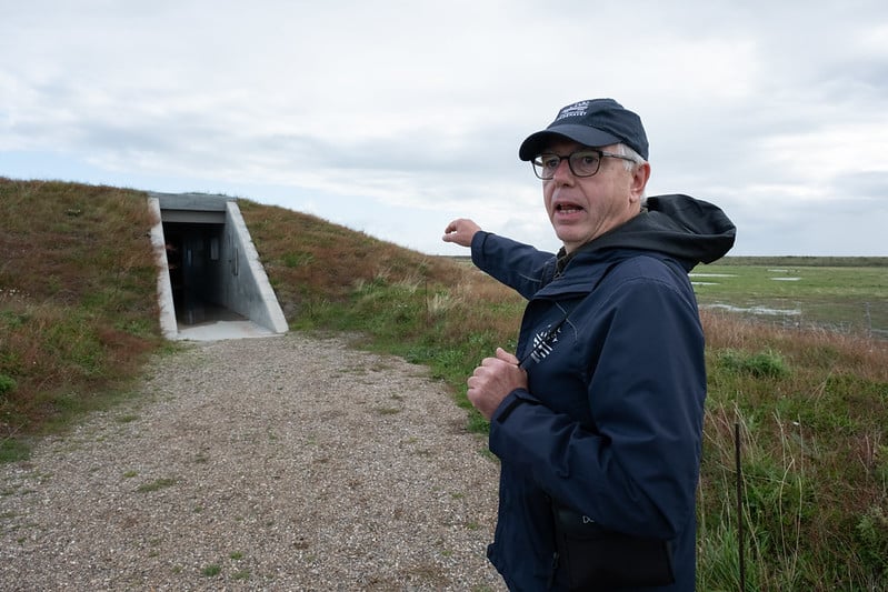 Jens Hansen points to a bird-watching building near a nature protection area in Wadden Sea National Park.