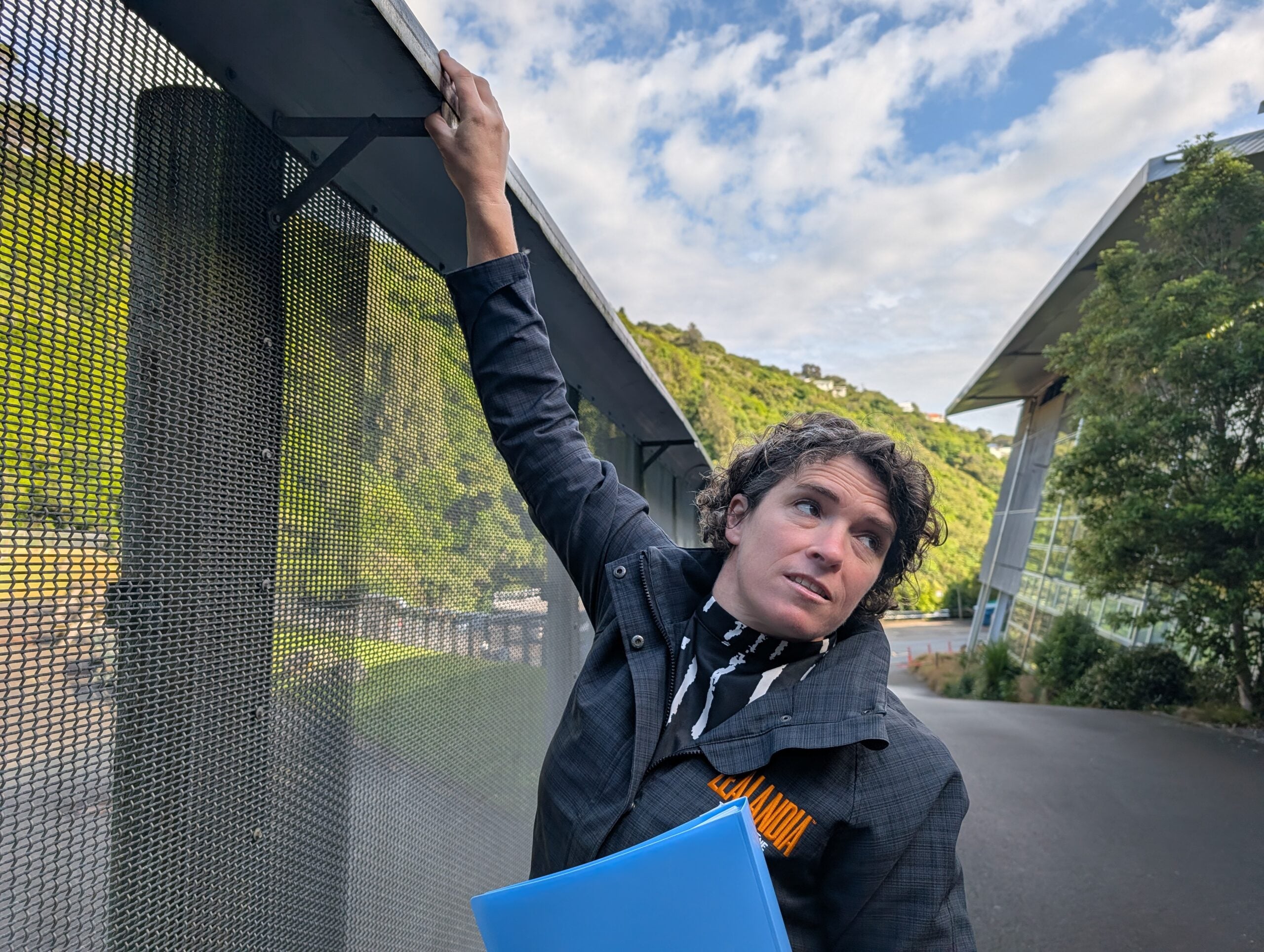 Danielle Shanahan, Zealandia’s CEO, shows a visitor the innovative fence surrounding the ecosanctuary in Wellington, New Zealand.