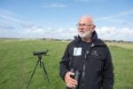 Klaus Melbye, director of the Wadden Sea Centre, surveys wildlife at a dike in Wadden Sea National Park.