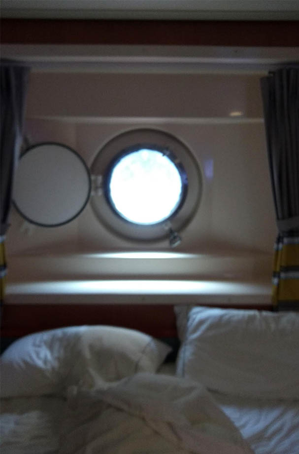 This cruise ship passenger was moved from a specious balcony suite to this tiny quarantine cabin with a porthole.