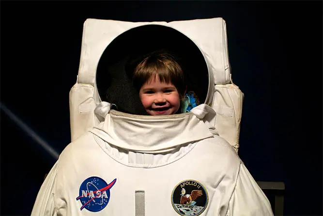 The author's daughter enjoying a summer adventure at a space center.